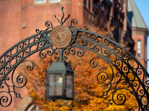 Trees in fall colors frame the Class of 1902 gate facing Hamilton Avenue in New Brunswick.